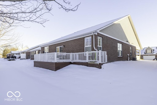 view of snow covered rear of property