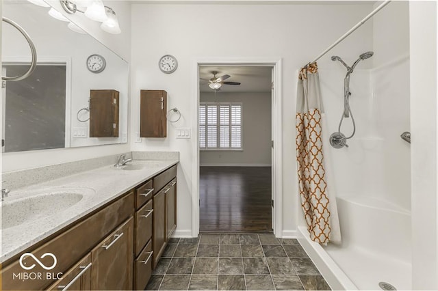 bathroom featuring ceiling fan, a shower with shower curtain, and vanity