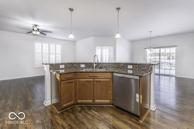 kitchen with sink, decorative light fixtures, stainless steel dishwasher, ceiling fan with notable chandelier, and a kitchen island with sink