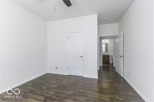 unfurnished bedroom with ceiling fan and dark hardwood / wood-style floors