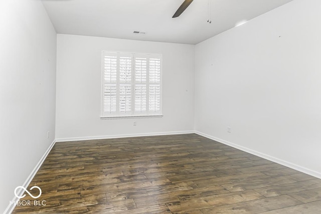 spare room featuring dark wood-type flooring and ceiling fan