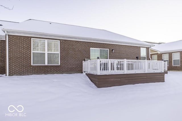 view of snow covered back of property