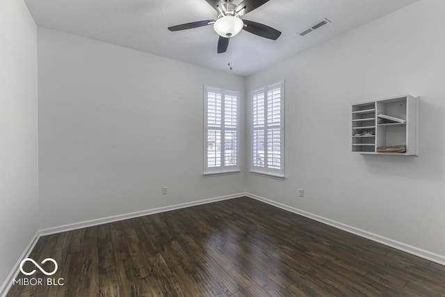 empty room featuring ceiling fan and dark hardwood / wood-style floors