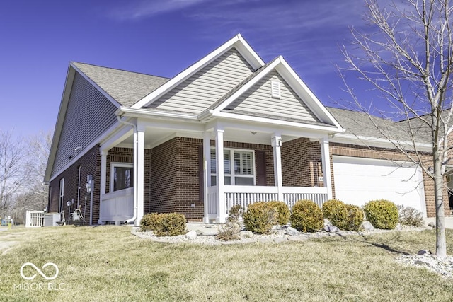 view of front facade with covered porch, brick siding, a front lawn, and an attached garage