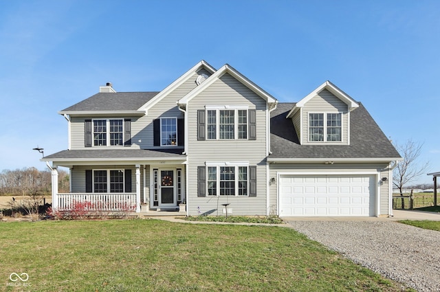 view of front of house featuring a garage, a front lawn, and a porch