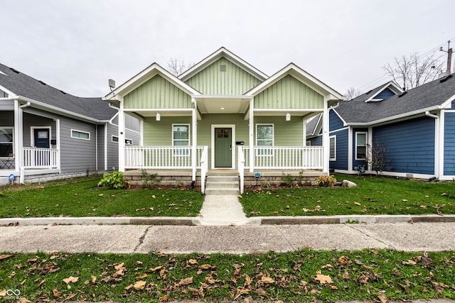 view of front of house with a porch and a front yard