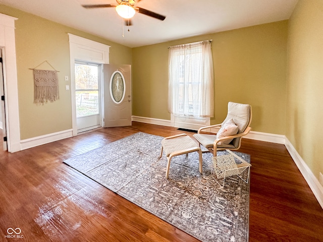 living area with hardwood / wood-style floors, ceiling fan, and a wealth of natural light