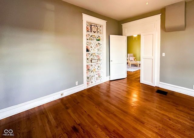 interior space featuring hardwood / wood-style floors and built in features