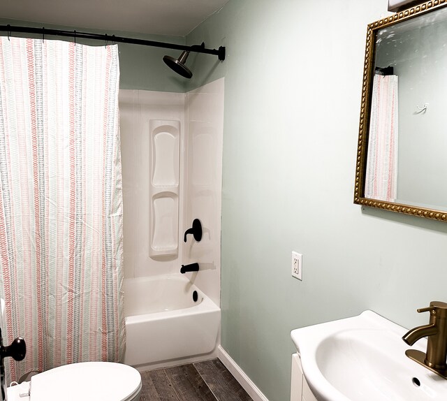 full bathroom featuring hardwood / wood-style flooring, toilet, sink, and shower / tub combo