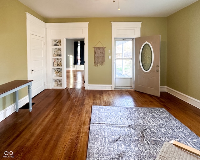 entrance foyer featuring ceiling fan and dark wood-type flooring