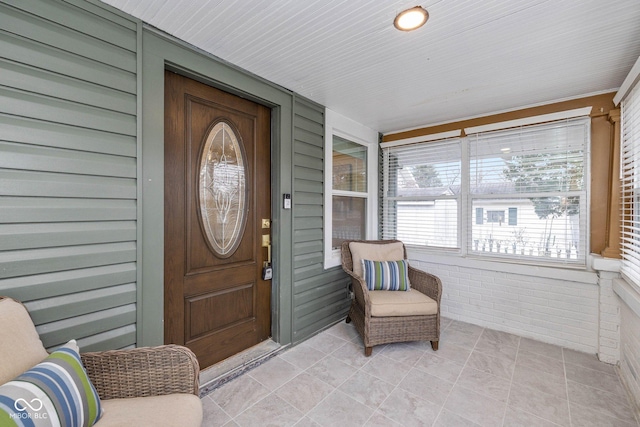 view of exterior entry with covered porch