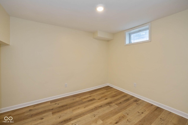 basement with light hardwood / wood-style flooring