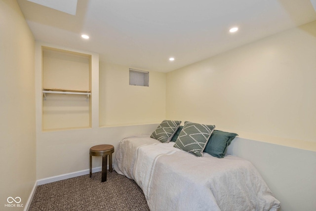 bedroom featuring a walk in closet, a closet, and carpet