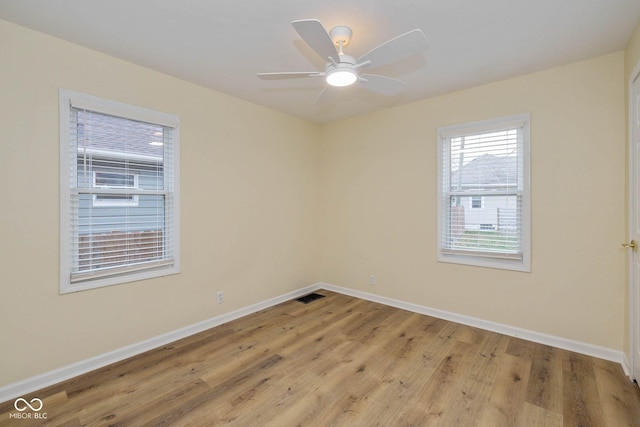 unfurnished room with light wood-type flooring and ceiling fan