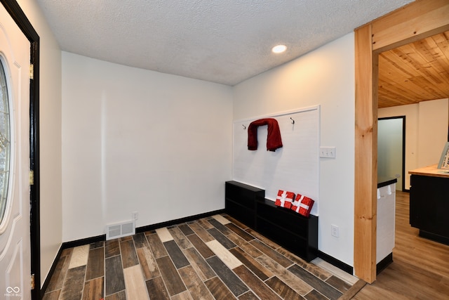 foyer featuring a textured ceiling and dark hardwood / wood-style flooring