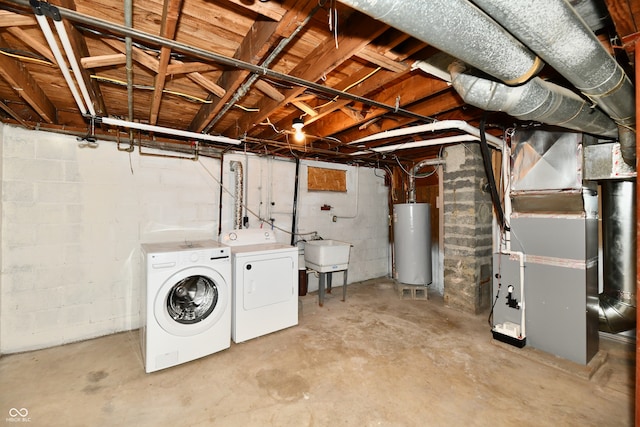 basement featuring heating unit, washing machine and dryer, sink, and water heater