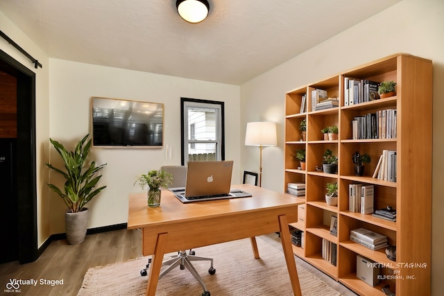 office area with light hardwood / wood-style floors