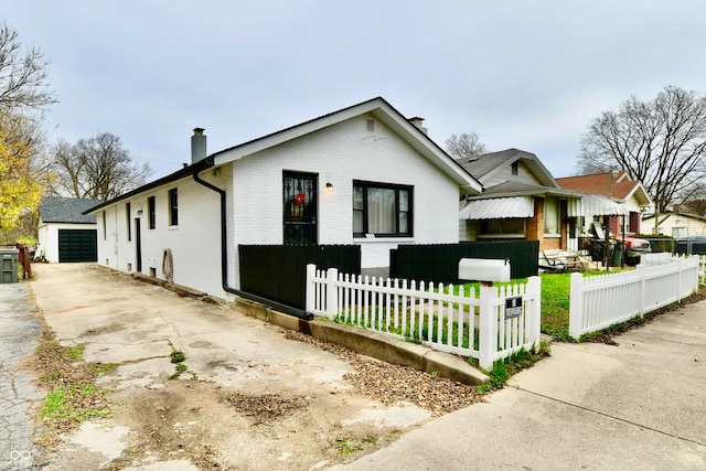 view of front facade with an outbuilding and a garage