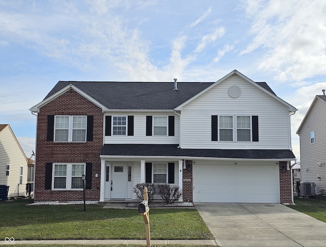 view of front of house featuring a front lawn and a garage