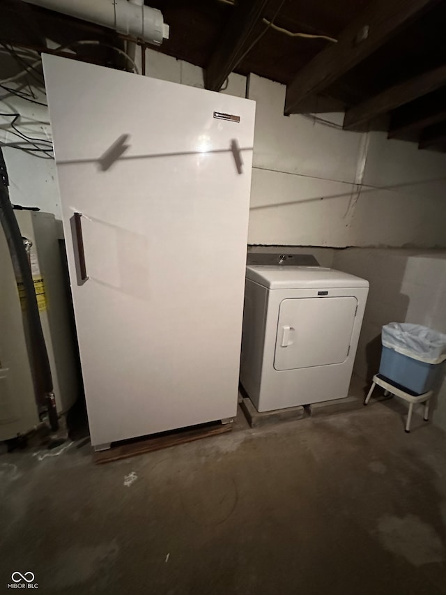 basement with washer / dryer, white fridge, and water heater