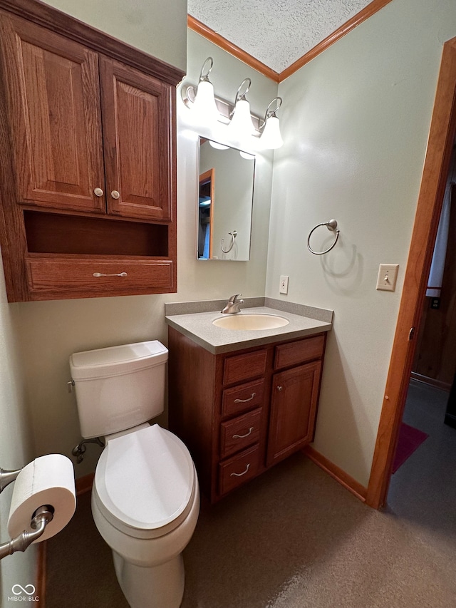 bathroom featuring vanity, toilet, crown molding, and a textured ceiling