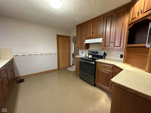 kitchen with electric range and a textured ceiling