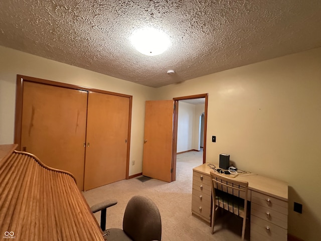 home office with light carpet and a textured ceiling