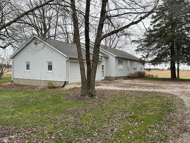 view of home's exterior featuring a lawn and a garage