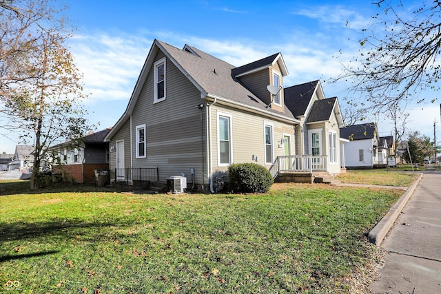 view of property exterior featuring a lawn and central AC