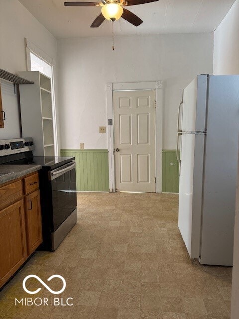 kitchen featuring ceiling fan, white fridge, and electric stove