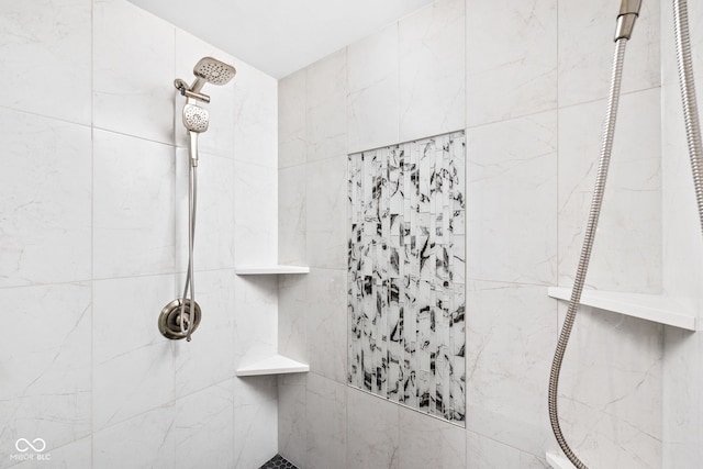 bathroom with a tile shower