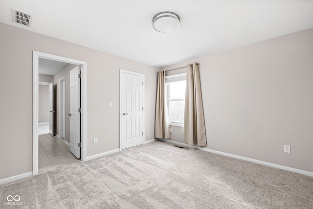 unfurnished bedroom with light colored carpet