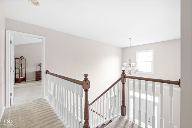 stairs featuring carpet and a notable chandelier