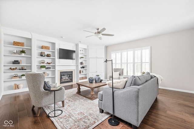 living room featuring ceiling fan and dark wood-type flooring