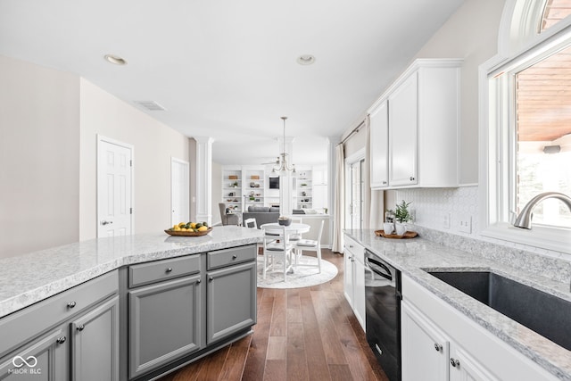 kitchen featuring gray cabinetry, sink, pendant lighting, dishwasher, and dark hardwood / wood-style floors