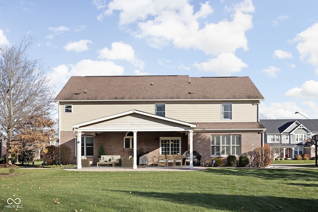 rear view of house featuring outdoor lounge area, a patio area, and a yard