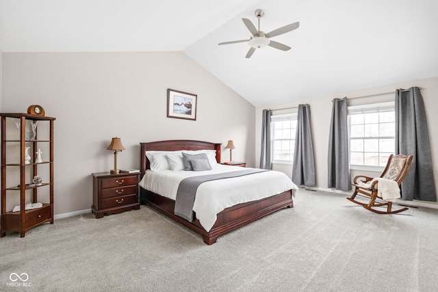 carpeted bedroom with ceiling fan and vaulted ceiling