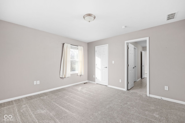 unfurnished bedroom featuring light carpet