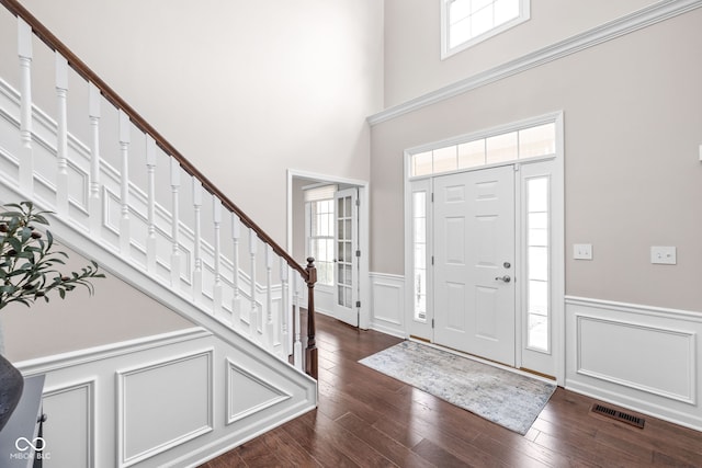 entryway with a high ceiling and dark wood-type flooring