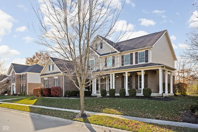 view of front of house featuring a front lawn and covered porch