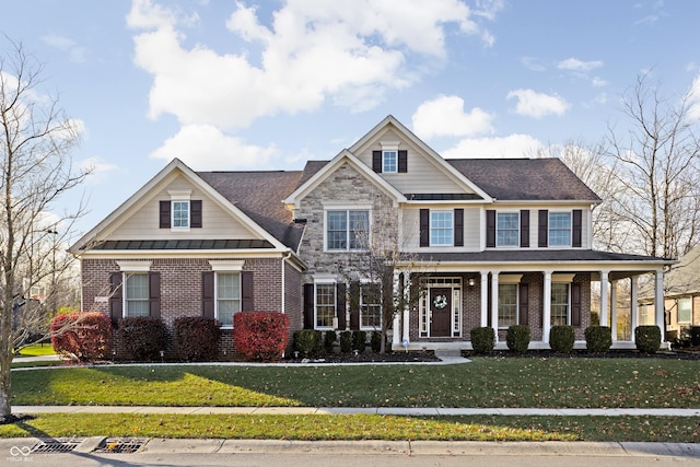 view of front facade with a front yard and covered porch