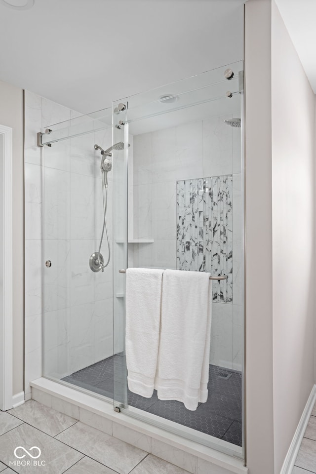 bathroom featuring a shower with door