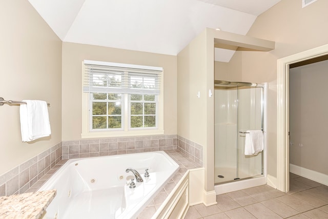 bathroom featuring tile patterned flooring, vanity, vaulted ceiling, and plus walk in shower