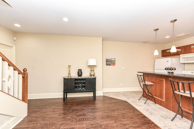 interior space featuring pendant lighting, dark hardwood / wood-style flooring, and white appliances