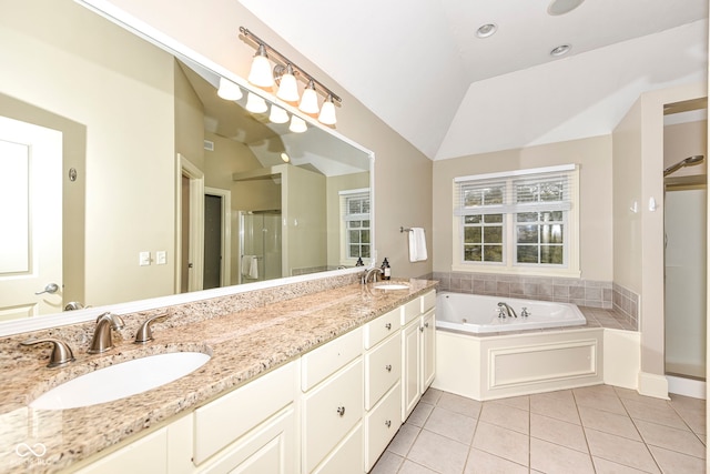 bathroom featuring tile patterned flooring, vanity, separate shower and tub, and lofted ceiling