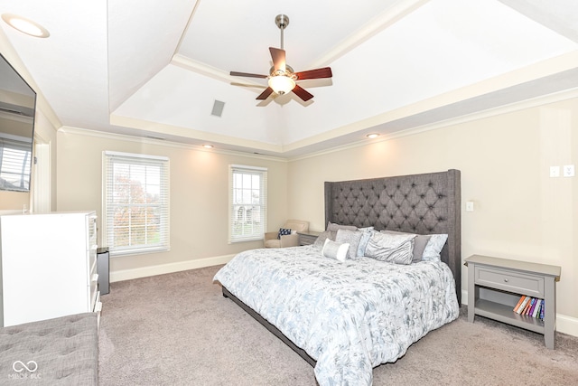 bedroom featuring carpet flooring, a raised ceiling, ceiling fan, and ornamental molding