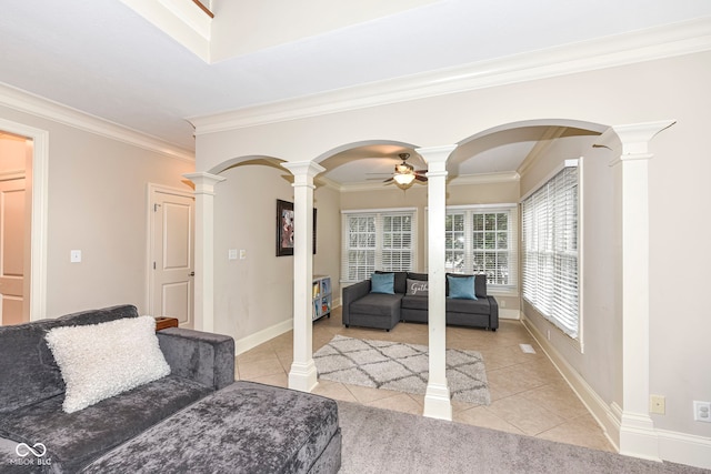 living room with ceiling fan, light tile patterned flooring, ornamental molding, and ornate columns