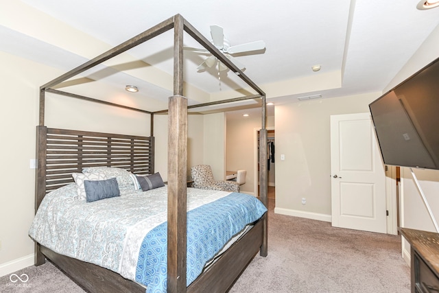 carpeted bedroom featuring ceiling fan and a spacious closet