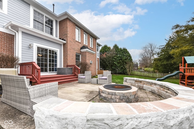 view of patio / terrace with a playground and a fire pit