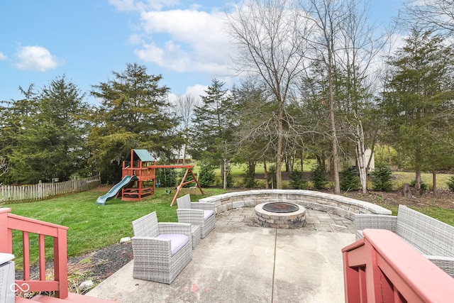 view of patio with a playground and an outdoor fire pit